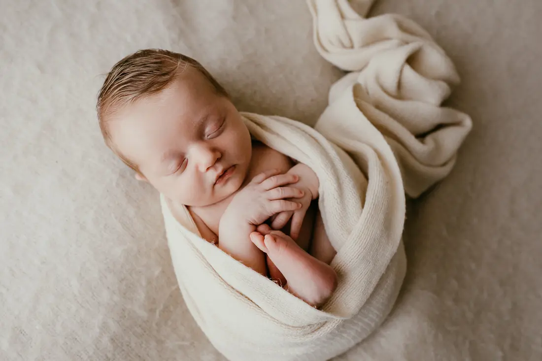 newborn baby in neutral wrap