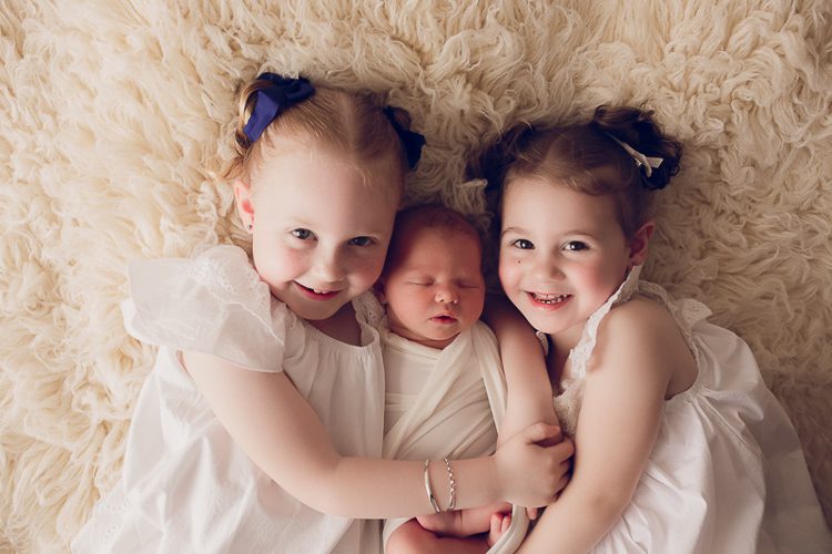 siblings cuddling their newborn sister in Warrnambool Victoria