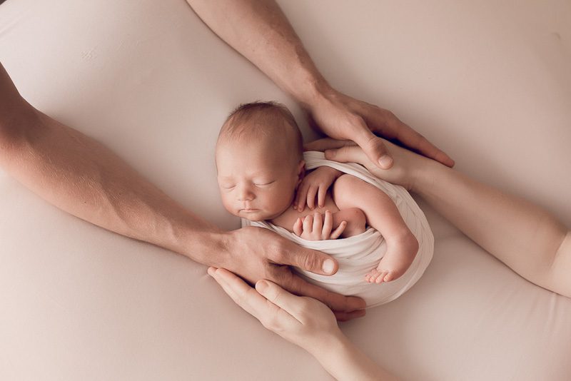 newborn photo of baby in parents arms
