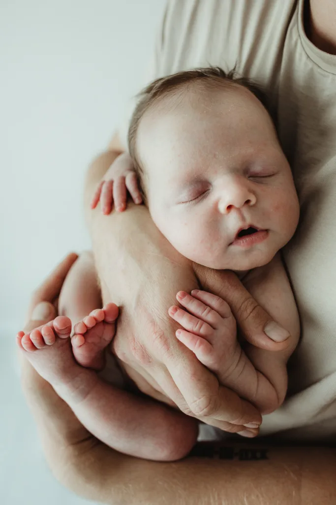 bub glow held on dads chest for photography